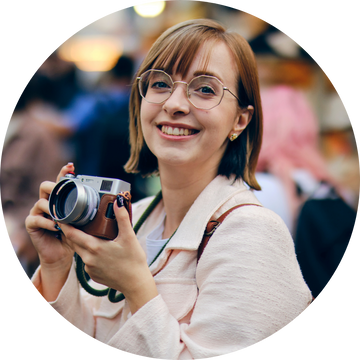 A mom with short hair holding a camera 
