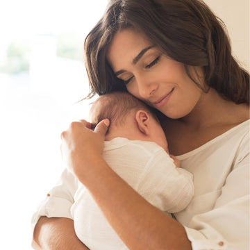 Mom holding a sleeping baby 