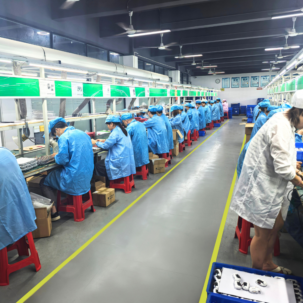 The factory assembly line with workers working hard in blue uniforms 