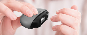 Adult holding an electric nail clipper to cut nails