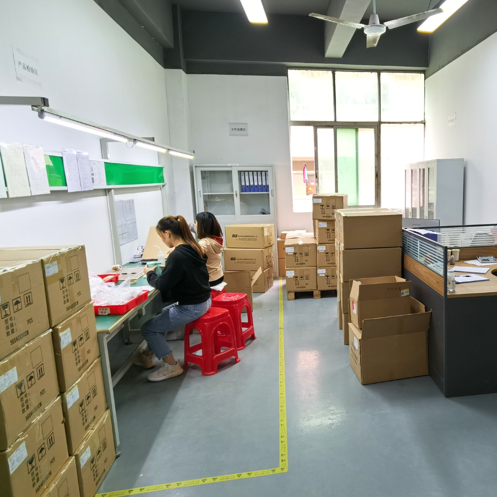 Two people working in a warehouse with boxes and shelves