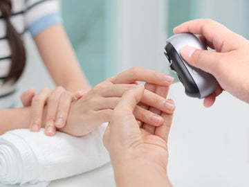 Electric nail clipper for safe and easy child nail care: parents gently and precisely trimming their child's nails