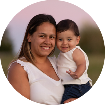 A mom holding a child outdoors