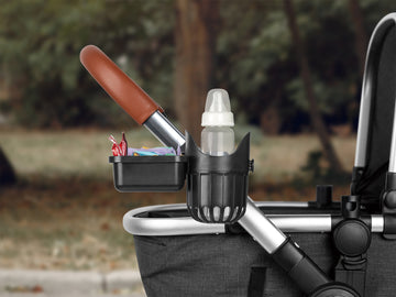Detachable cup holder with snacks and feeder attached to a stroller outdoors