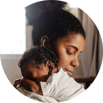 A mom holding a baby close together