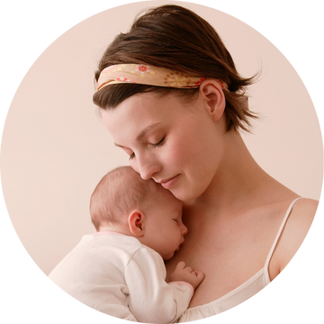 A mom holding a sleeping baby