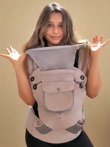 Woman wearing a gray baby carrier 