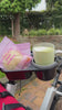 Stroller with attached snack tray holding juice box and cookies for toddler snack time